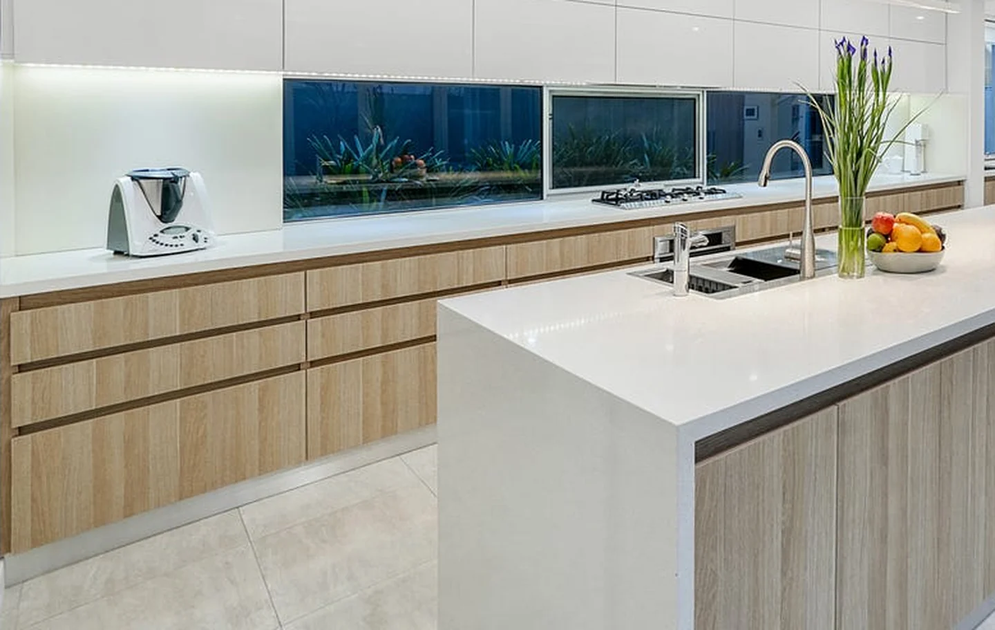 Large format floor tiles running through the kitchen and living area of a finished Perth home